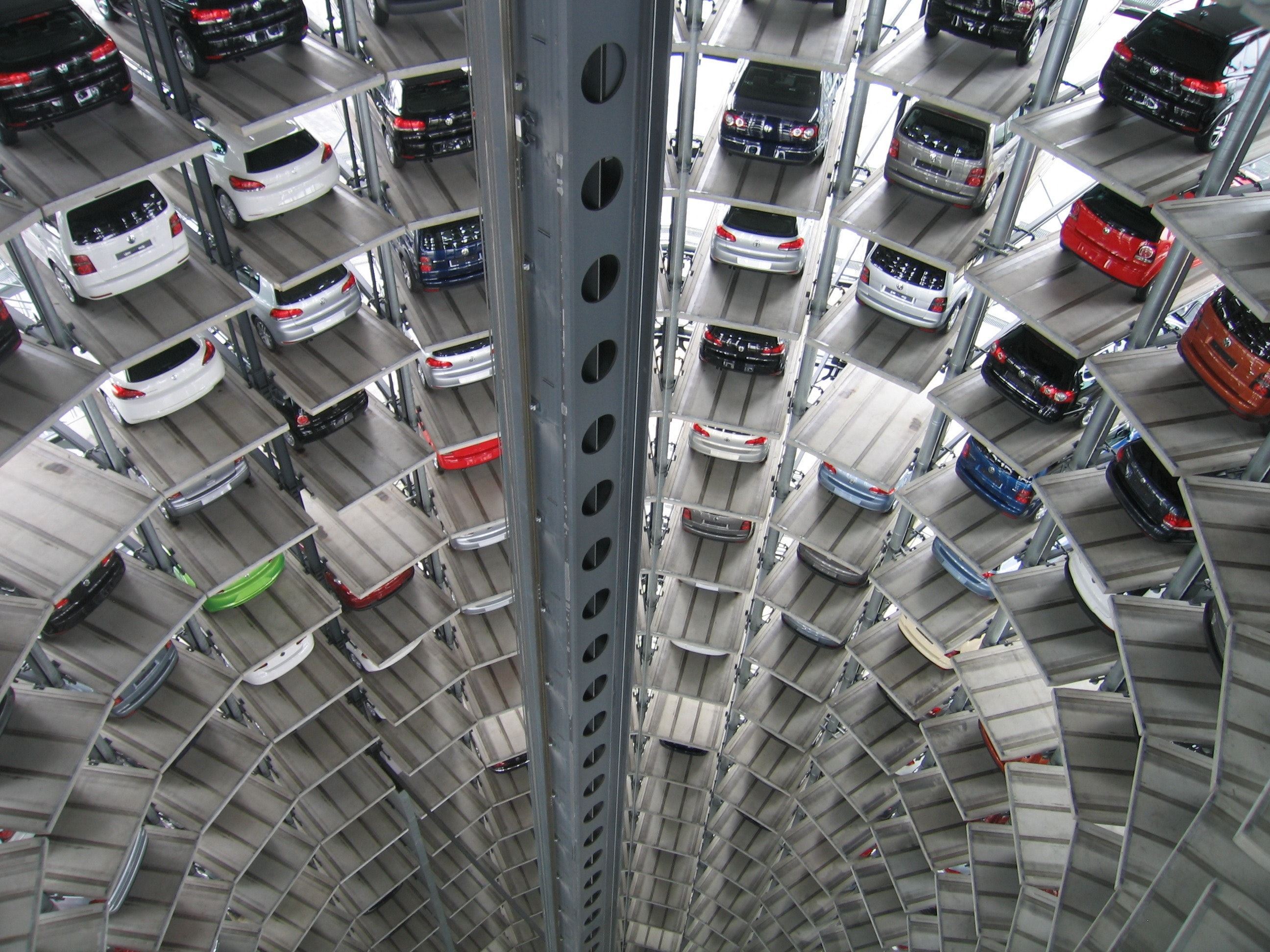 In een cirkel geparkeerde auto's in een parkeergarage. De parkeergerage gaat erg de hoogte in.
